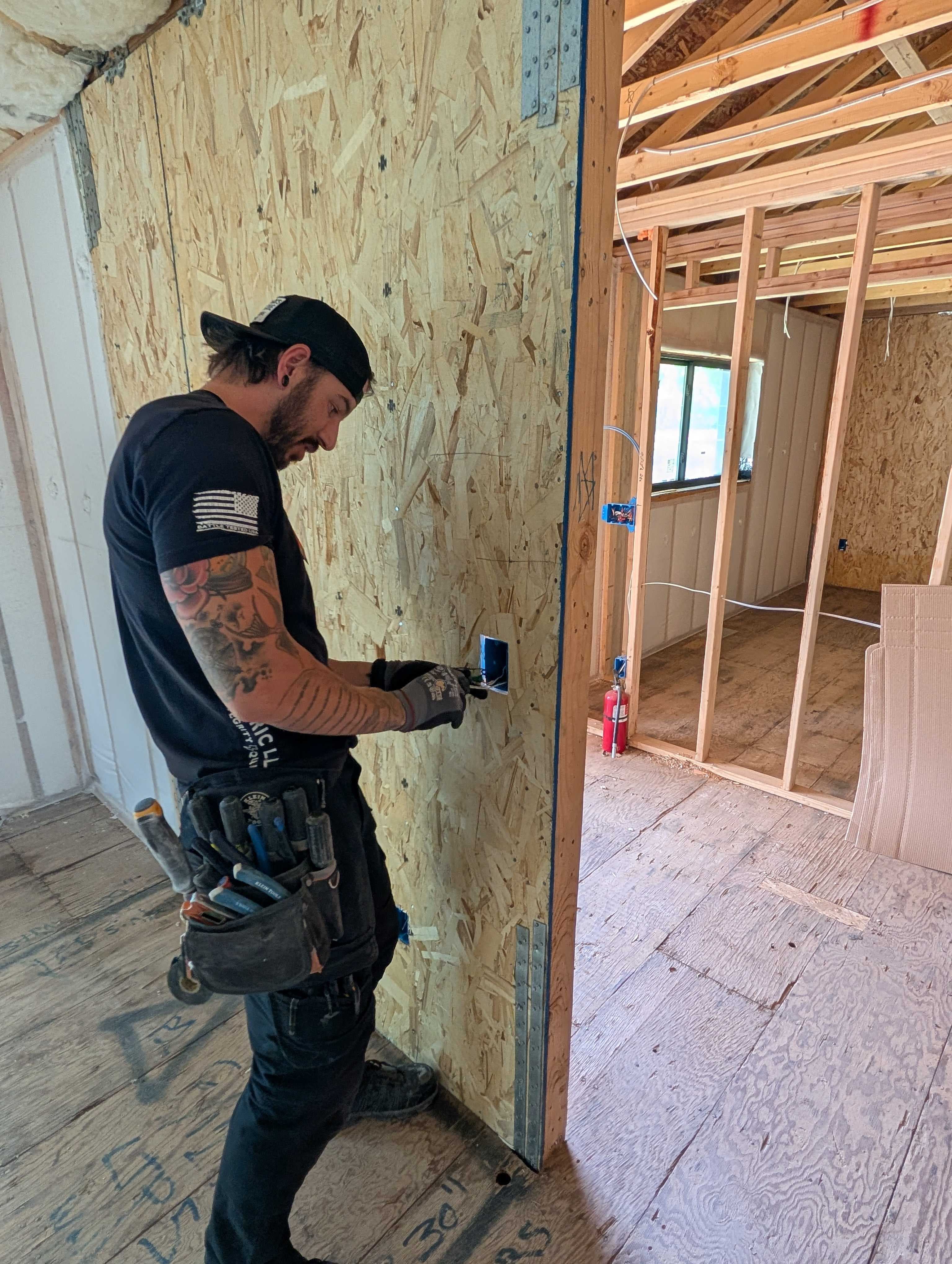 Avery installing a smart device box during a remodel