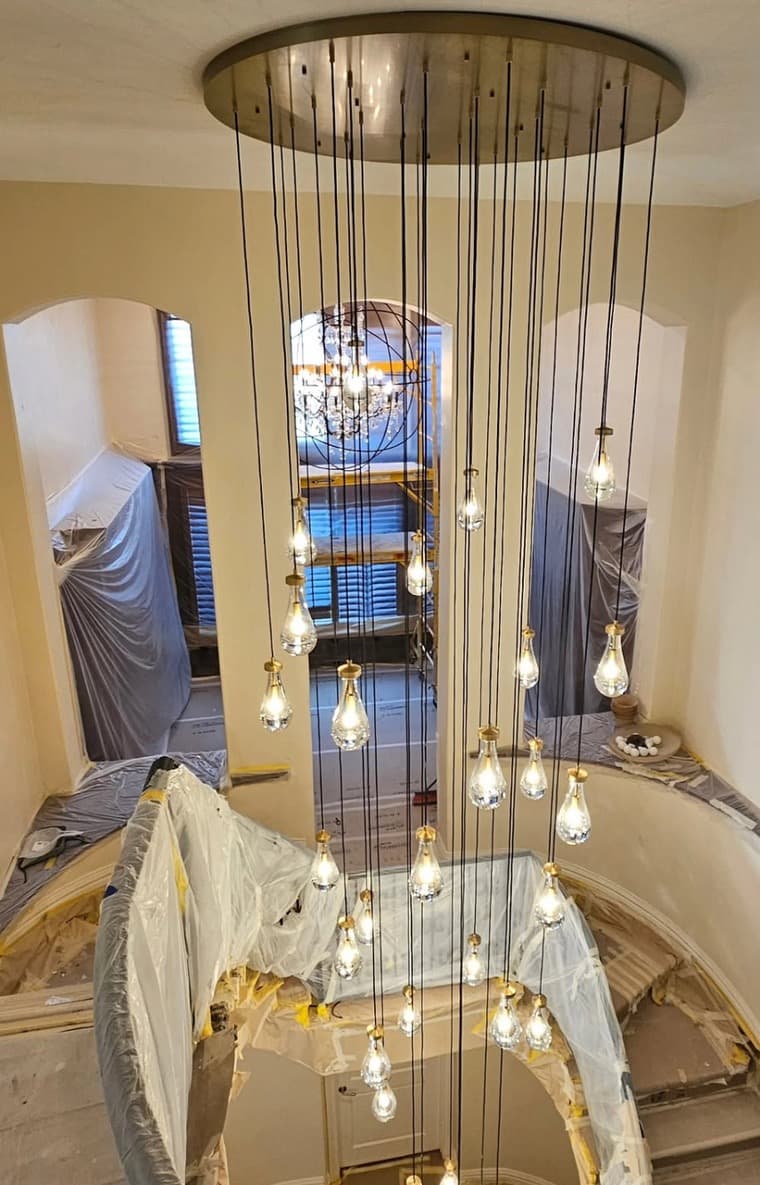 Custom 400-pound crystal chandelier install in a two-story entry