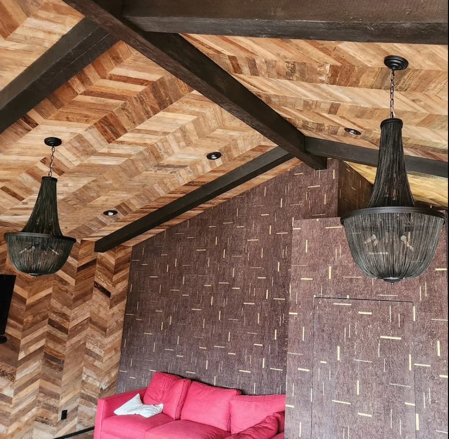 Chain chandeliers on a herringbone wood ceiling